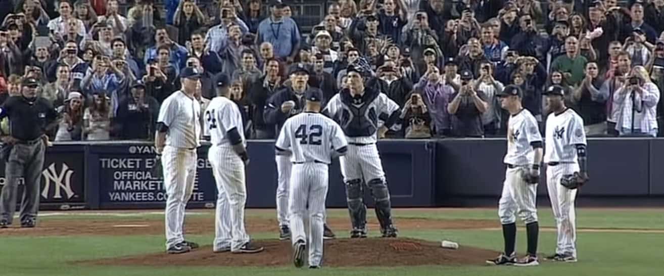 Image of Mariano Rivera celebrating after a key playoff save, showcasing his impact.